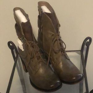 Olive green and brown boots with heel.